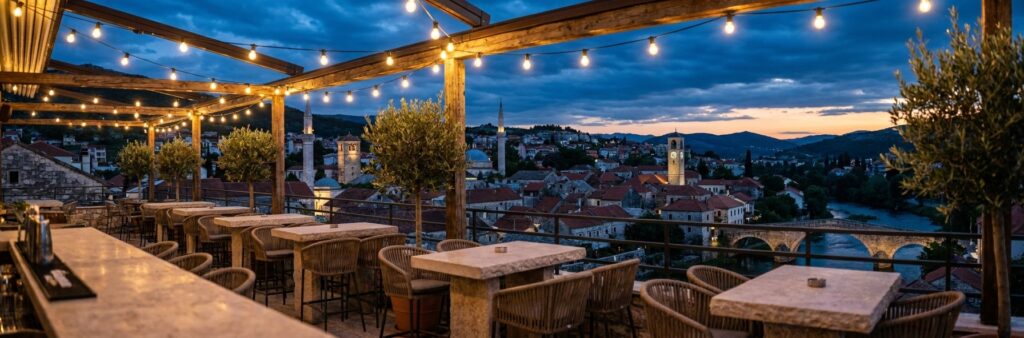 Rooftop terrace bar at dusk overlooking Trebinje's old town